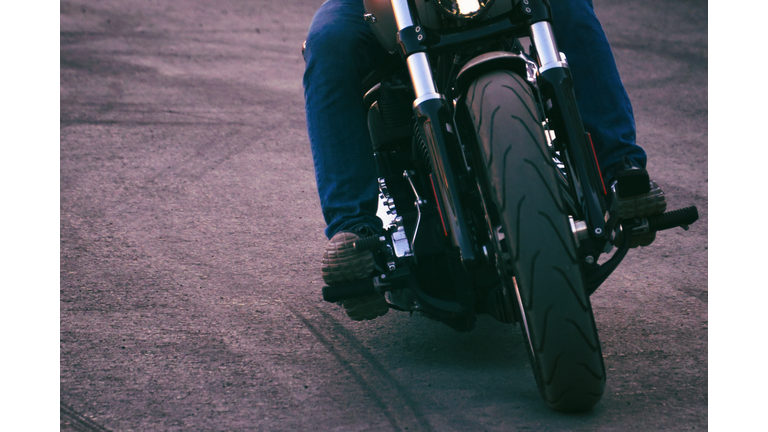 Biker iriding a motorcycle. Front view