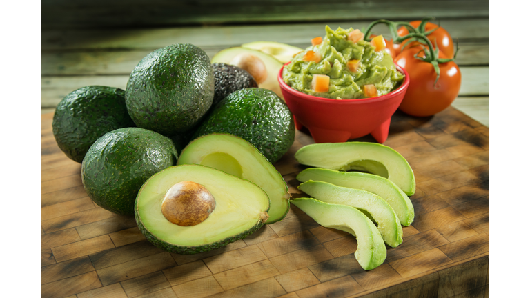 Avocados and tomatoes on a cutting board
