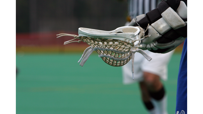 The head of a lacrosse being held 