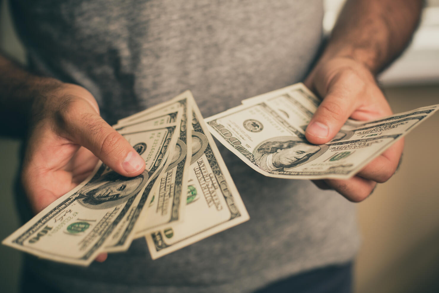 A man holds dollars in his hands