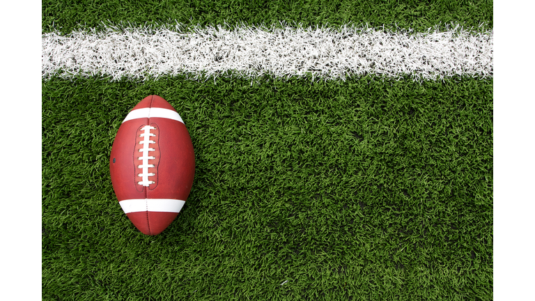 Overhead view of a football lying on a football field