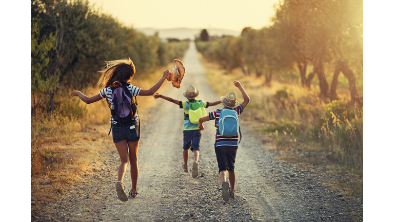 Three kids running on last day of school