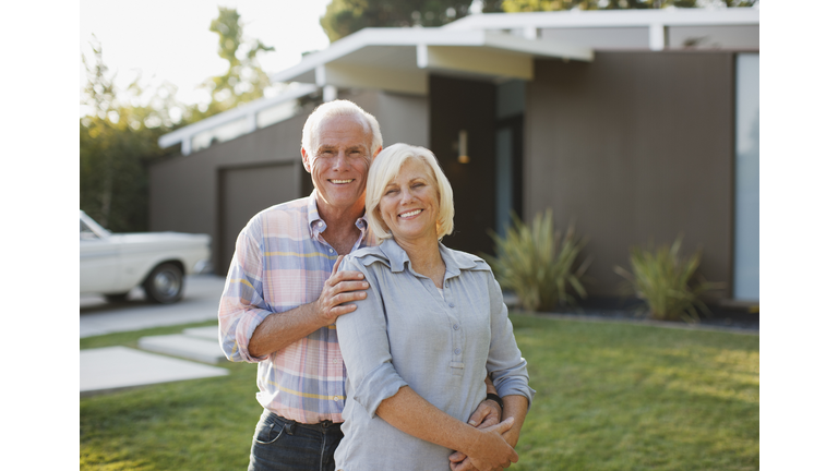 Smiling older couple standing outdoors