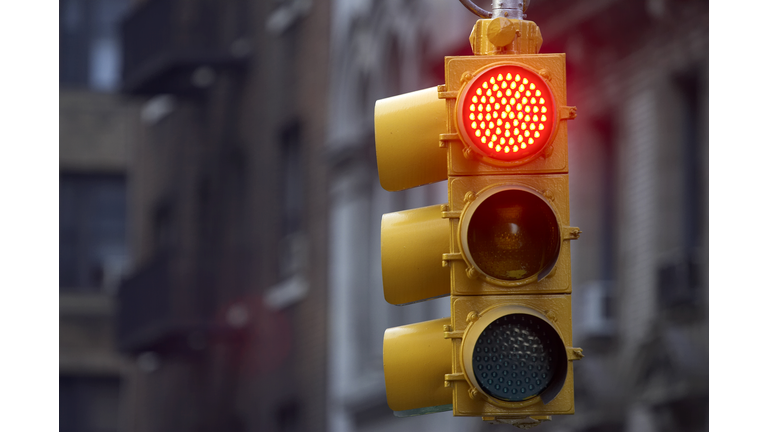 Traffic light on street with red signal lit up
