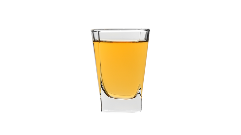 shot glass of strong alcohol whisky isolated on white bakcground