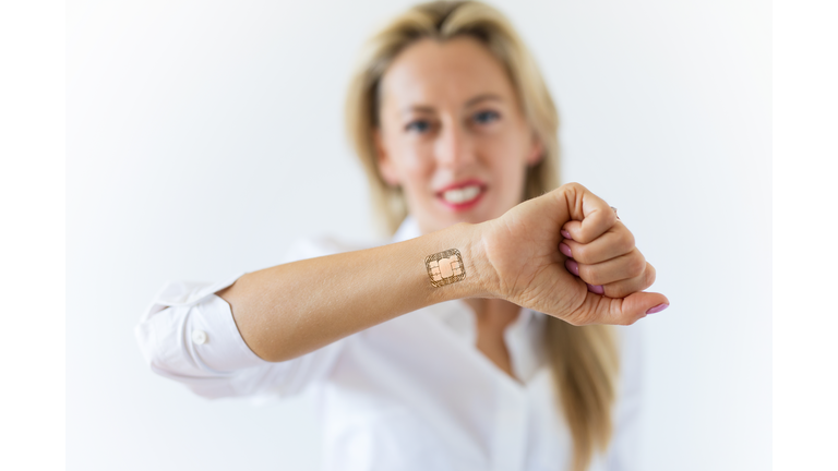 Woman with computer chip implant in hand