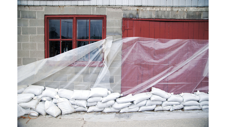 Sandbags and glass sheet on building wall