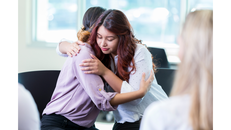 Counselor comforts patient during support group meeting