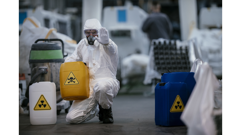 Factory worker wearing gas mask and radioactive protection suit