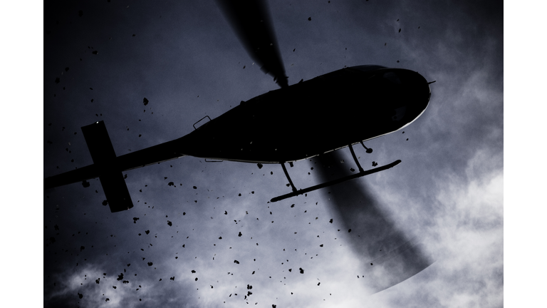 Helicopter scattering dirt seen from below