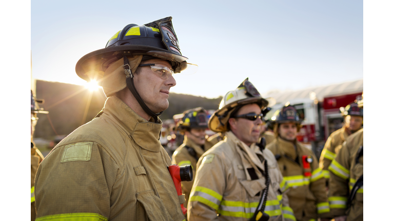 Firefighters standing at fire station