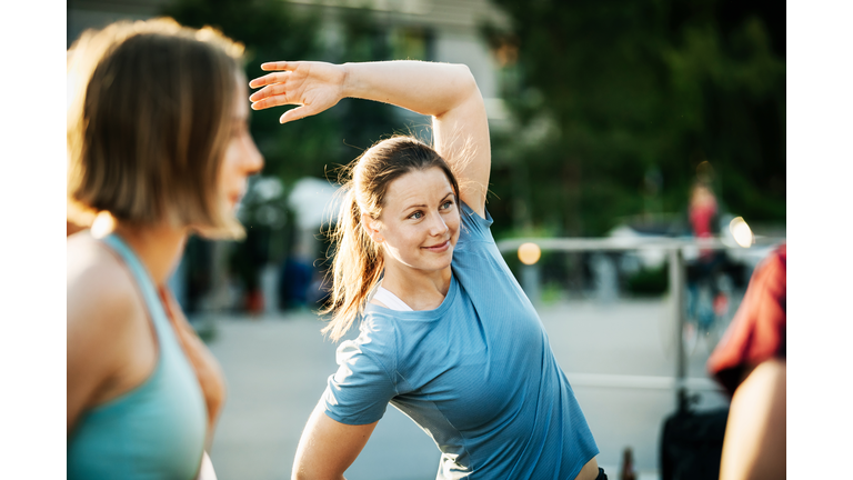 Women Warming Up Outside Together