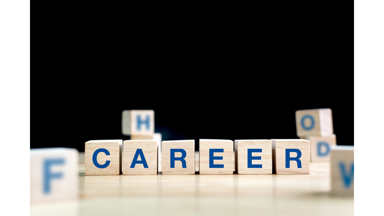 Wood cube and word career on wooden table with black background