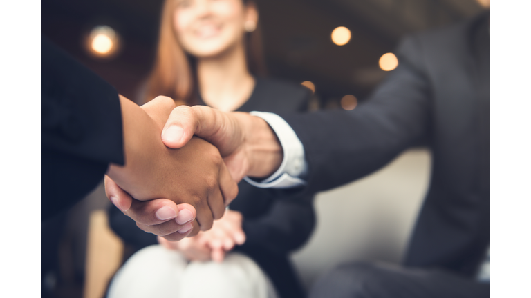 Businessmen shaking hands after meeting in a cafe