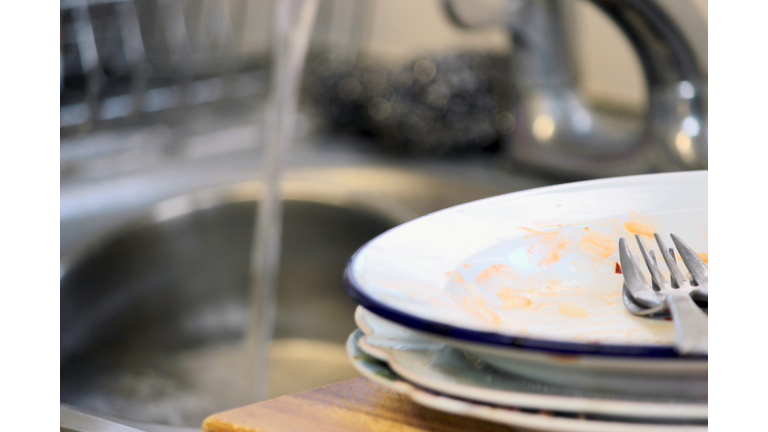 Untidy House -Dirty Dishes At Sink.