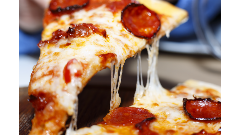 Closeup of a piece of pepperoni pizza. Italian pizza.