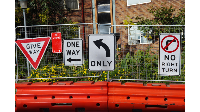 Multiple road signs near inner city road construction