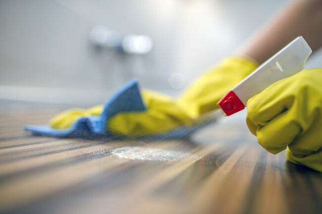 Cleaning kitchen table  with blue cloth