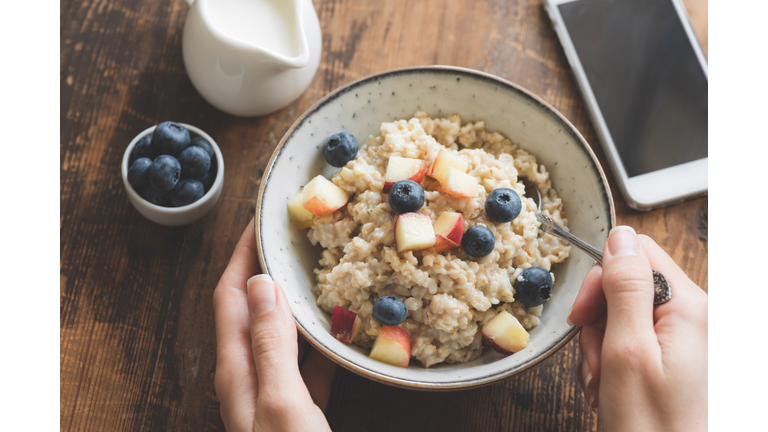 Eating healthy breakfast. Oatmeal porridge in bowl