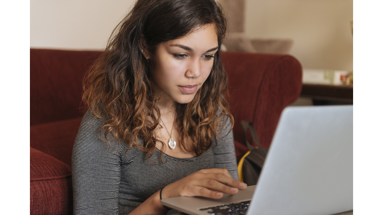 Young Woman Studies On Computer at Home for Higher Education