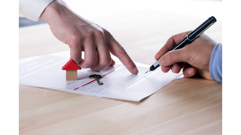 New homeowner signing contract of house sale or mortgage papers