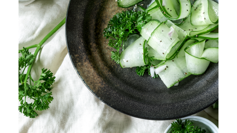 Close up cucumber salad and with chia seeds and the green parsley leaf in black plate , heathy salad for anti aging with rich of antioxidant organic food concept