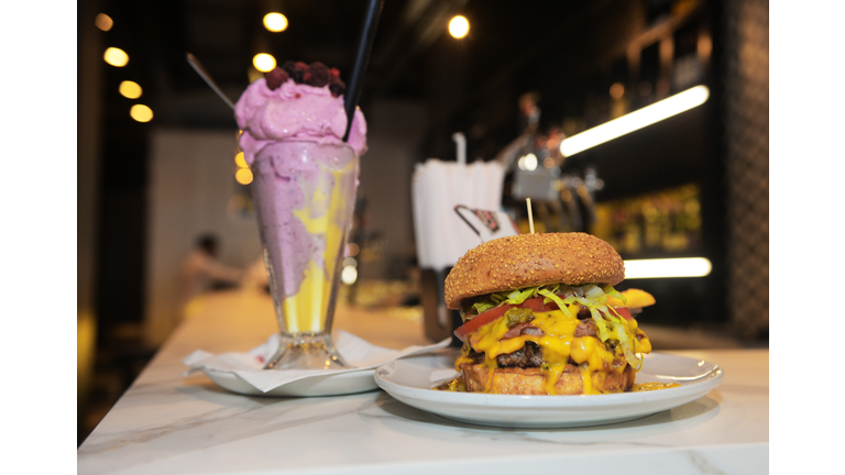 Cheeseburger and pink fruit milkshake