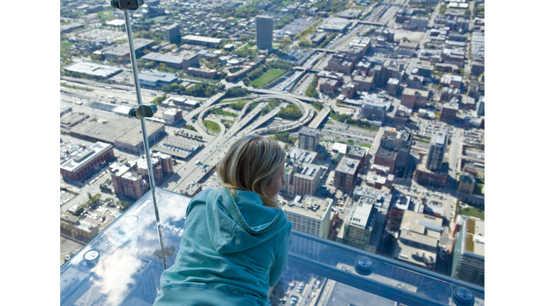 Tourist admiring view of Chicago from Sears Tower