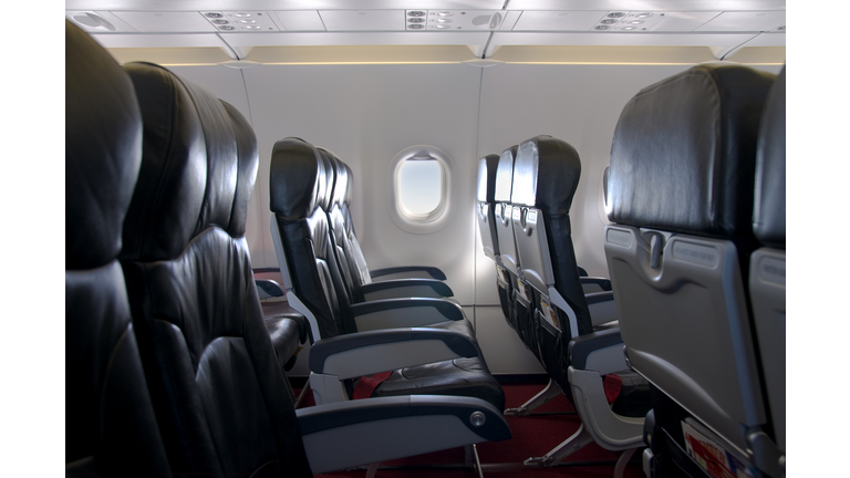 Premium Economy Class Seating Inside An Airplane Cabin