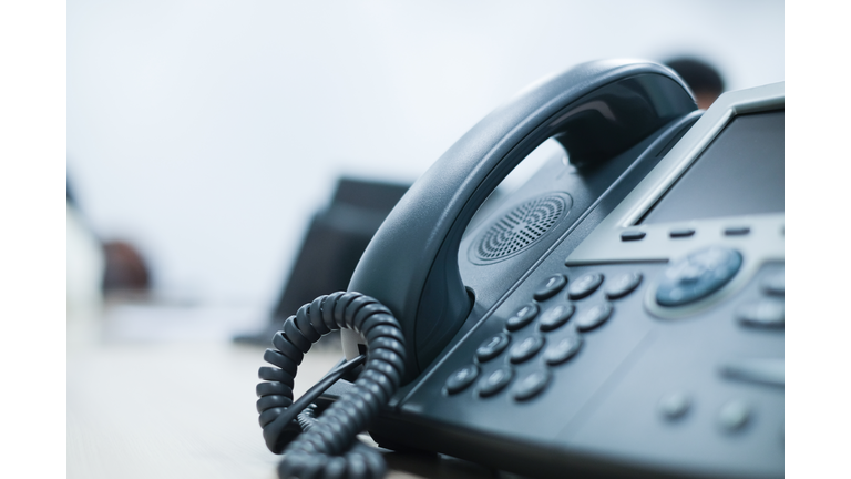 close up soft focus on telephone devices at office desk for customer service support concept