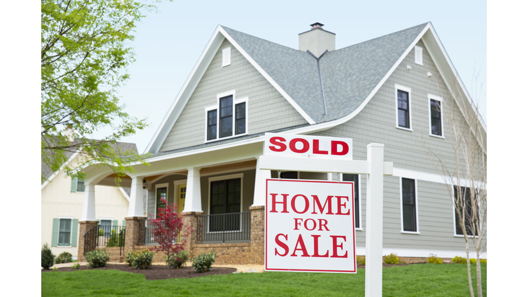 House with ""sold"" sign in front yard