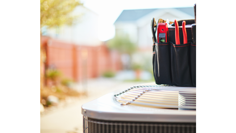 Air conditioner with maintenance tools in residential back yard