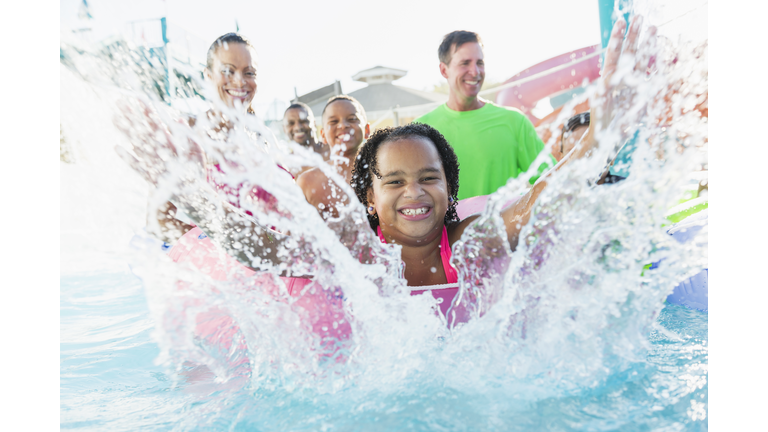 Girl having fun at water park with family and friends.