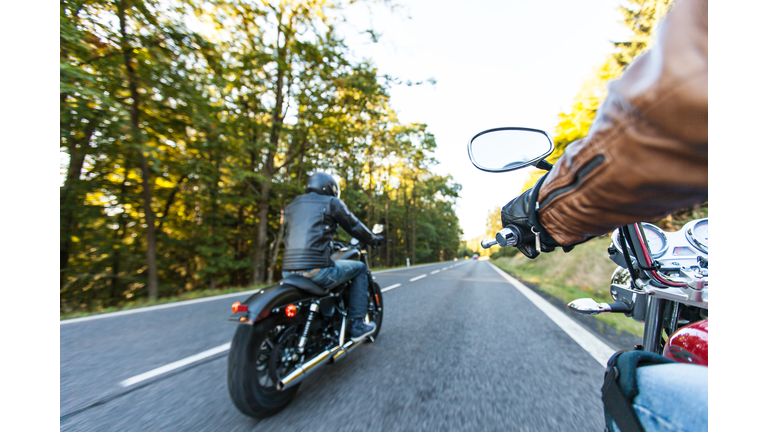 Man seat on the motorcycle on the forest road