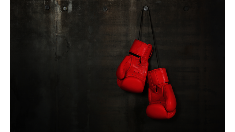 Close-Up Of Red Boxing Gloves Hanging On Wall