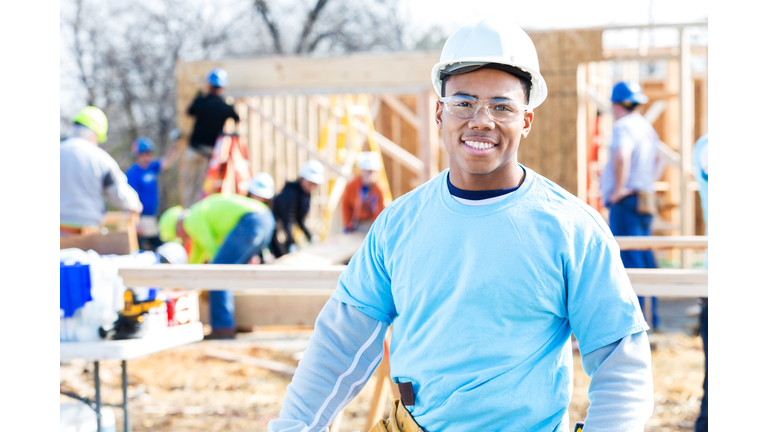 Confident volunteer construction foreman at work site