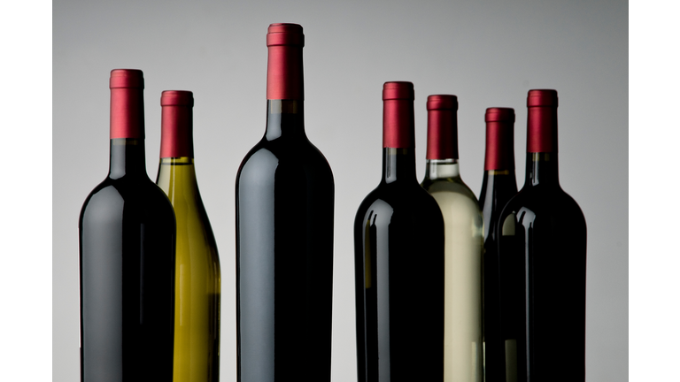 Close-Up Of Wine Bottles Over White Background