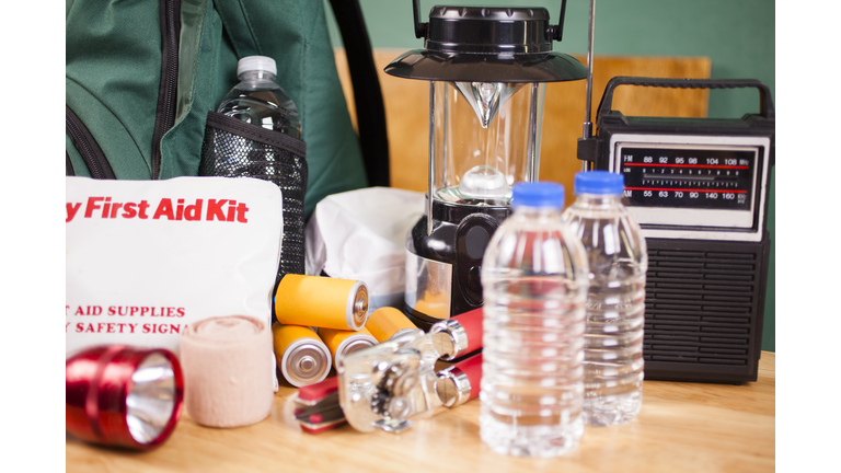 Emergency preparedness natural disaster supplies. Water, flashlight, lantern, batteries.