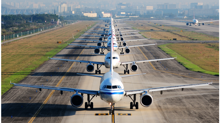 so many airplanes are in line on the runway waiting for take off