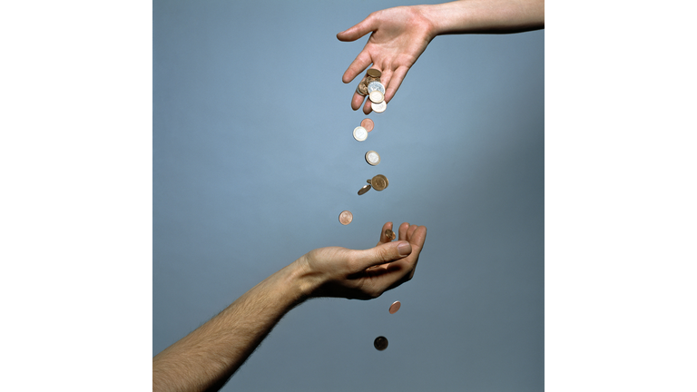 Hands dropping coins