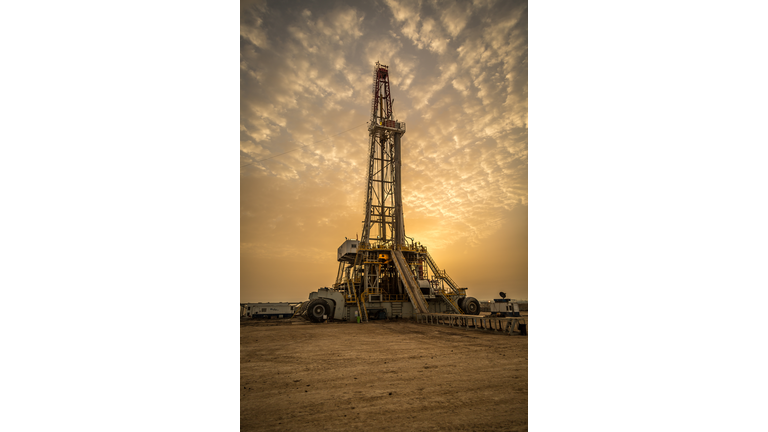 Oil drilling rig at dawn