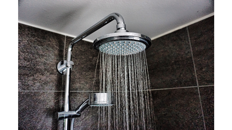 Close-Up Of Water Falling From Shower In Bathroom At Home