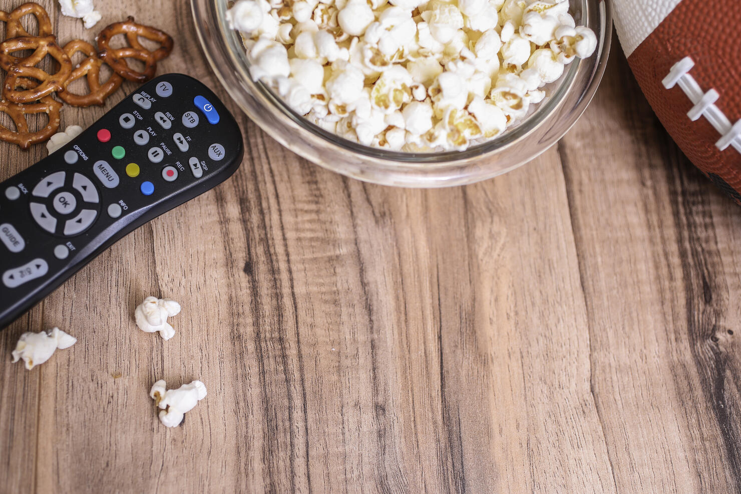 Watching the football game with snacks, drinks.