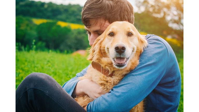 Guy and his dog, golden retriever, nature