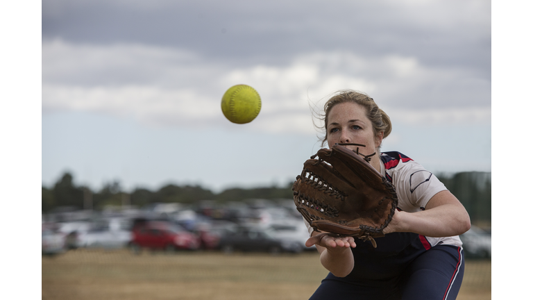Female softball player catching the ball