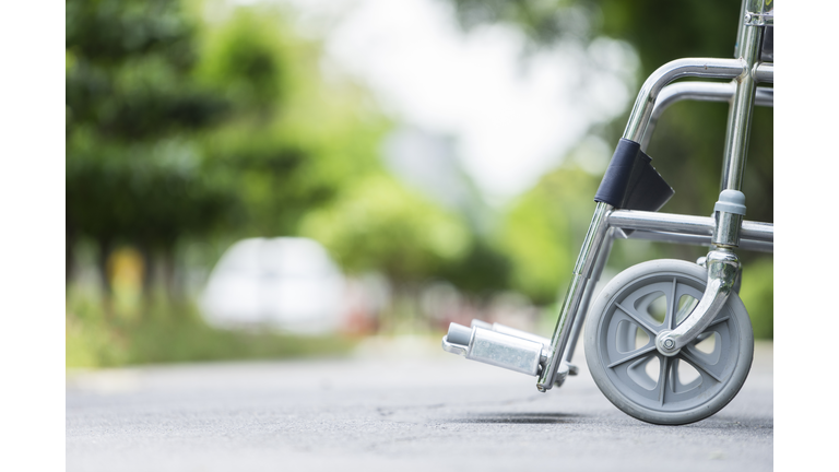 Empty wheelchair parked in park