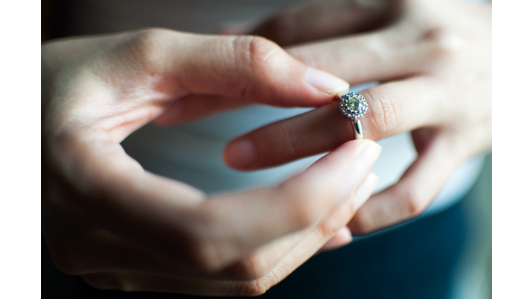 A woman wears her engagement ring