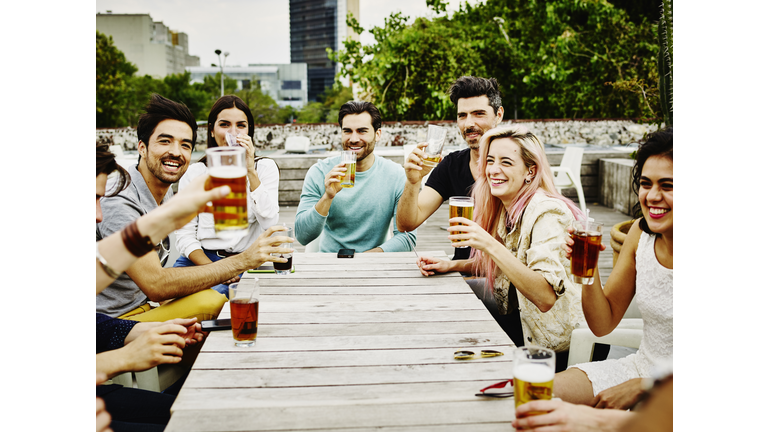 Group of friends raising glasses to toast