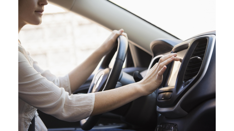 Caucasian woman using GPS system in car