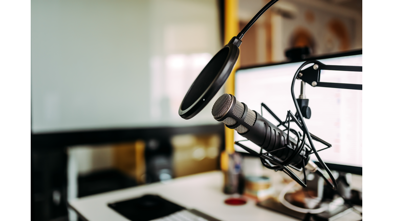 Close-up image of microphone in podcast studio.